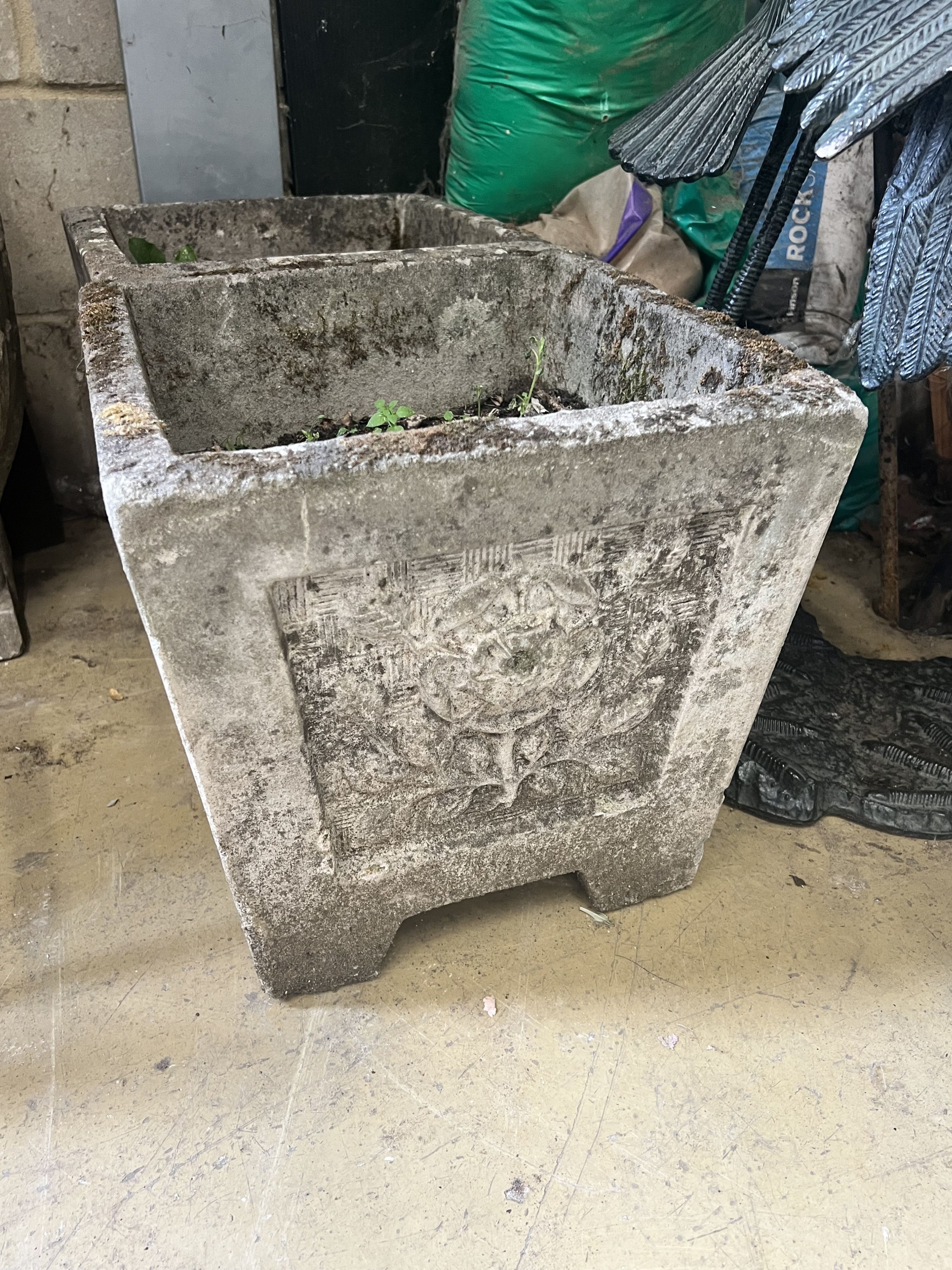 A pair of reconstituted stone square planters with rose motif, width 37cm height 36cm